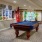 a pool table in a room with flags