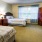 a bedroom with two beds and large windows